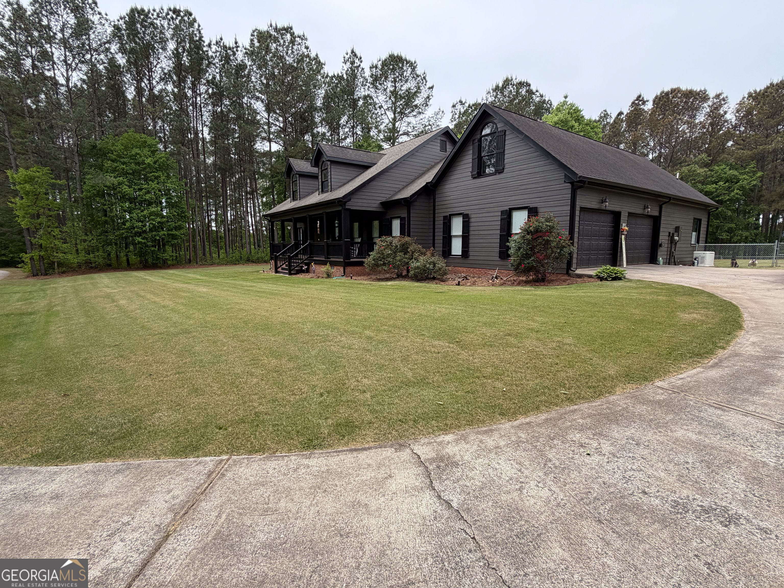 3385 Highway 83 Monticello, GA 31064 - Photo 2 of 47 a front view of a house with a garden