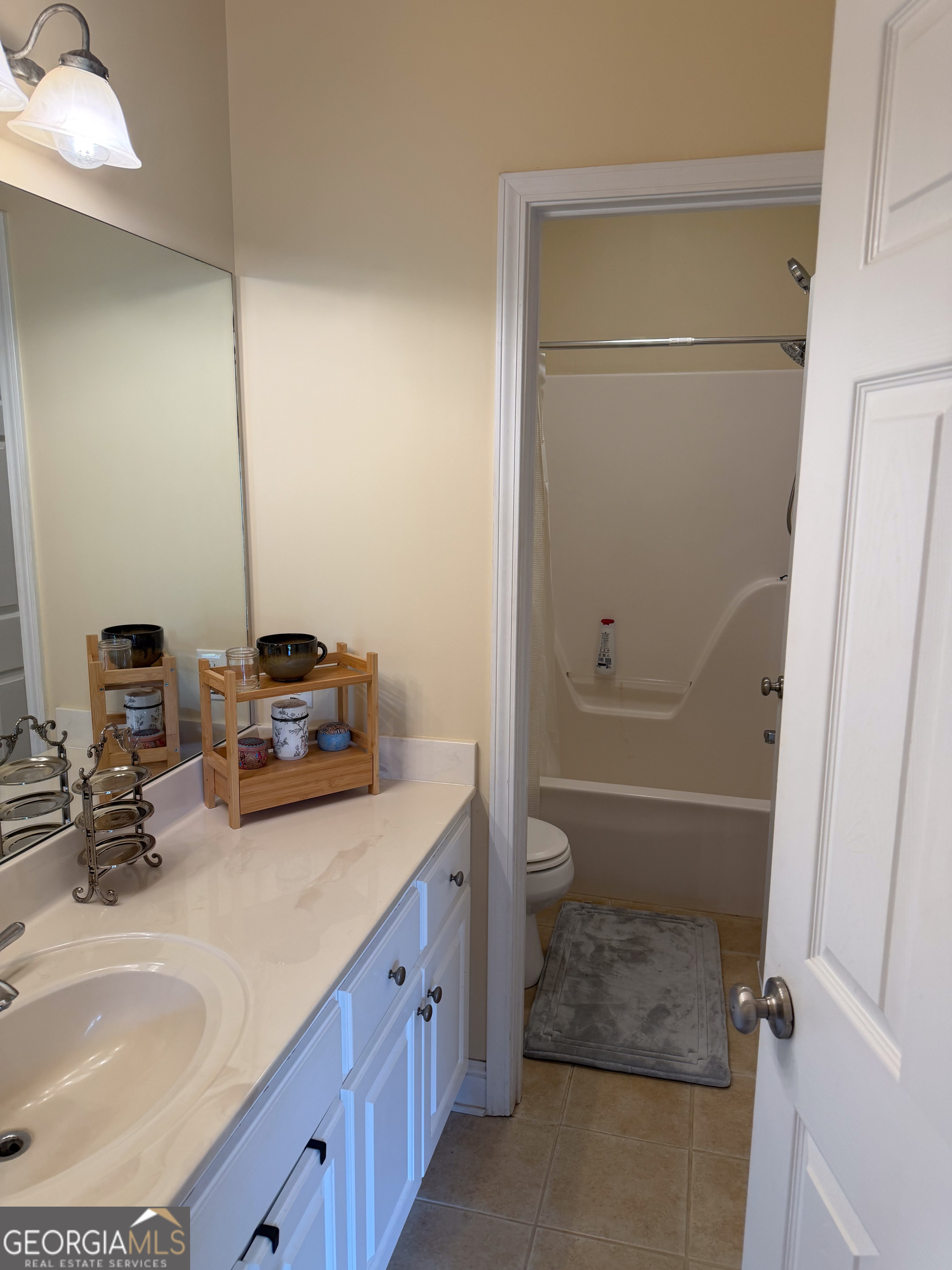 3385 Highway 83 Monticello, GA 31064 - Photo 31 of 47 a bathroom with a granite countertop sink a toilet and shower