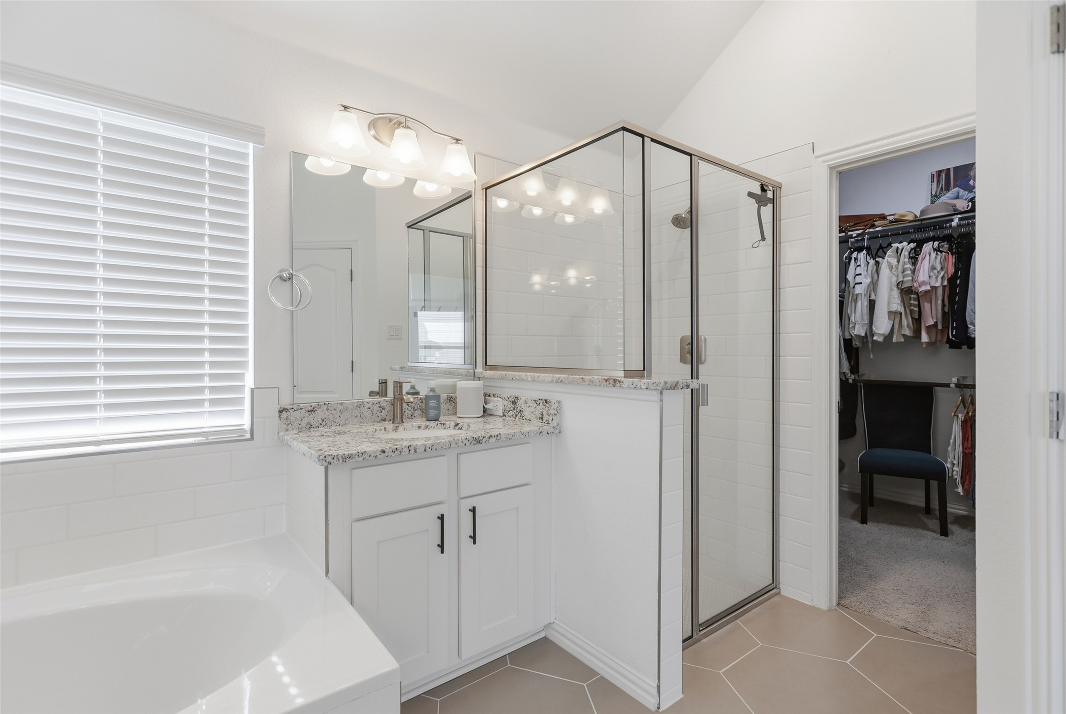 544 Cherrystone Loop Buda, TX 78610 - Photo 17 of 40 a bathroom with a shower sink and mirror