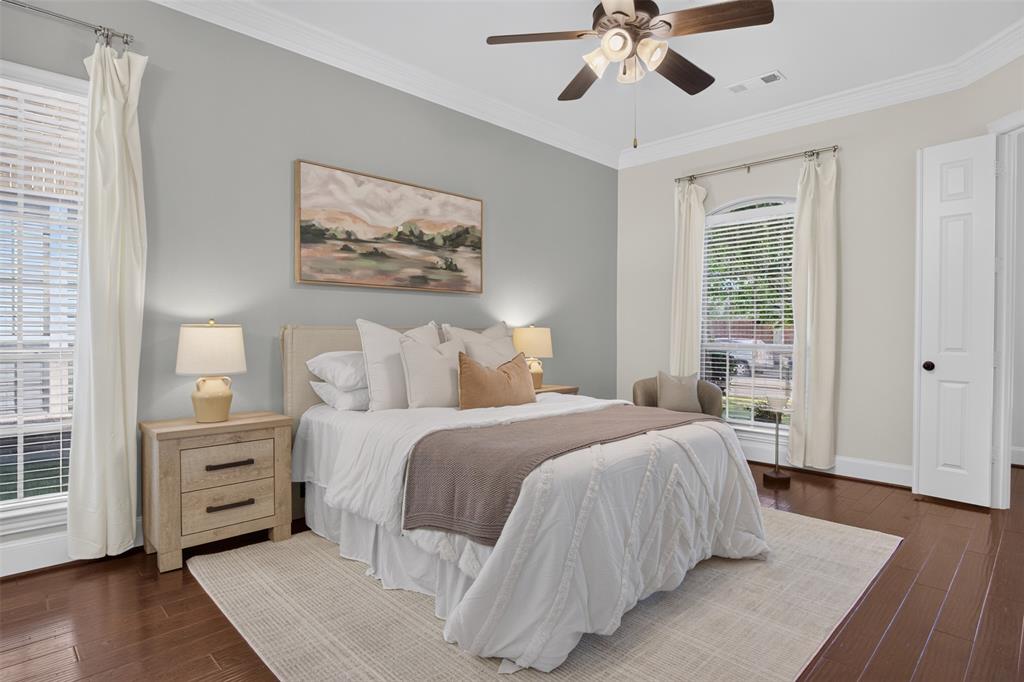 842 Sun Meadow Road Allen, TX 75013 - Photo 14 of 39 Spacious primary room featuring rich wood-finish flooring, a contemporary ceiling fan, elegant crown molding, and large windows with blinds