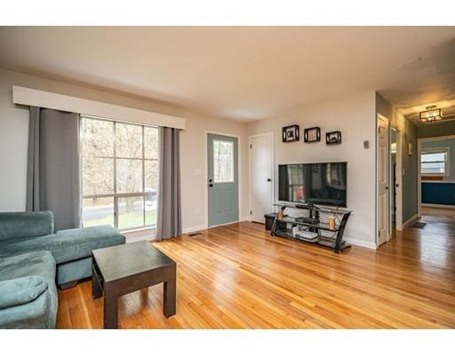 11 Enfield Road Pelham, MA 01002 - Photo 11 of 28 a living room with furniture a flat screen tv and a large window