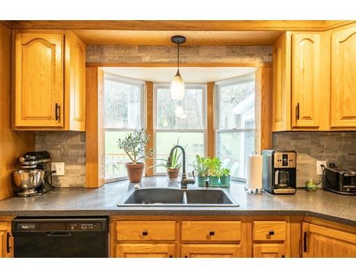 11 Enfield Road Pelham, MA 01002 - Photo 8 of 28 a kitchen with stainless steel appliances granite countertop a sink a counter and a window