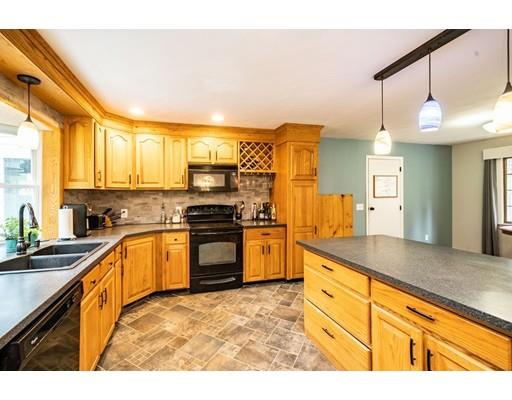 11 Enfield Road Pelham, MA 01002 - Photo 9 of 28 a kitchen with granite countertop a stove a sink and a refrigerator