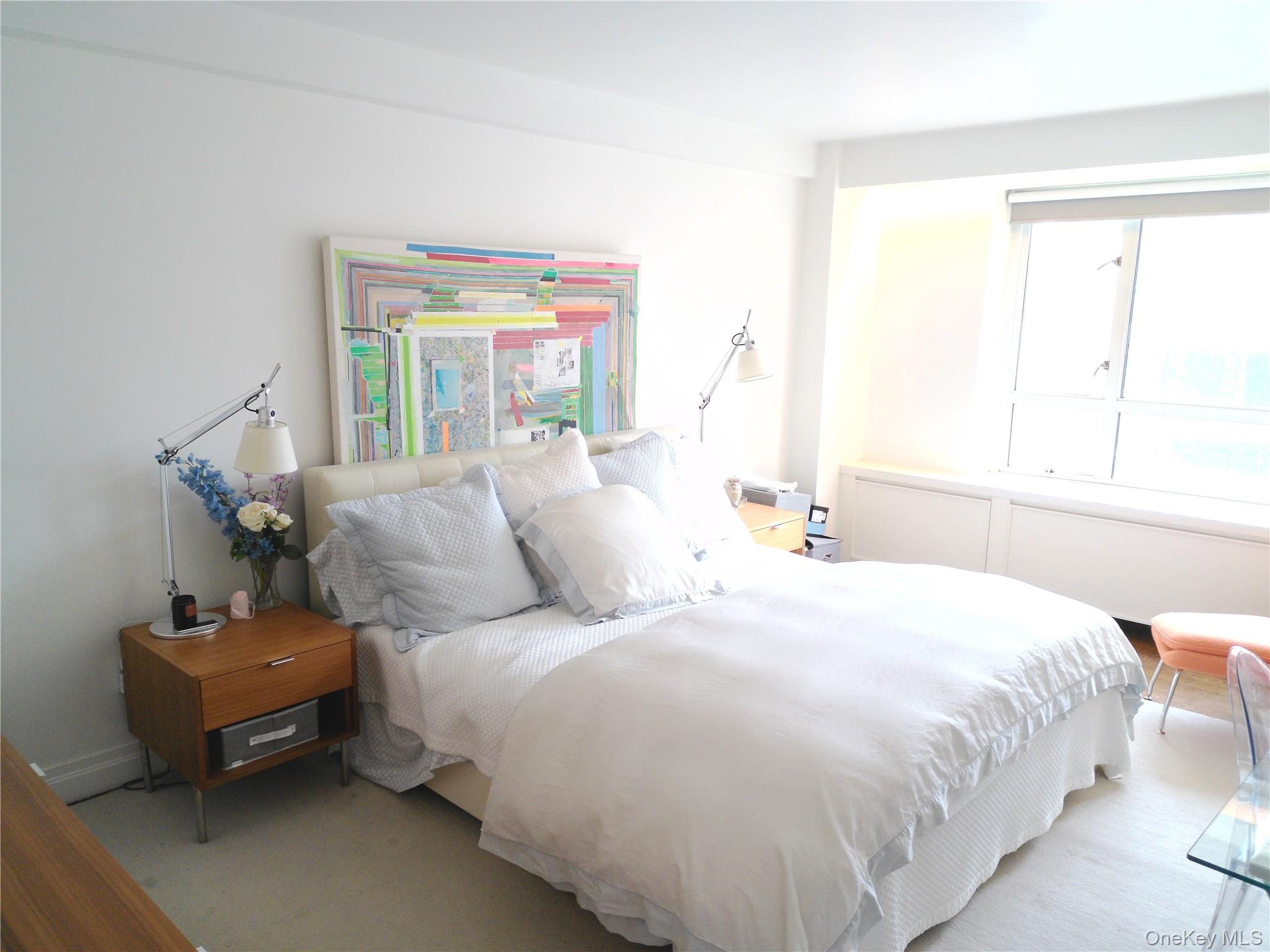 200 East 66th Street, Unit B1503 Manhattan, NY 10065 - Photo 14 of 24 a bedroom with a bed and window