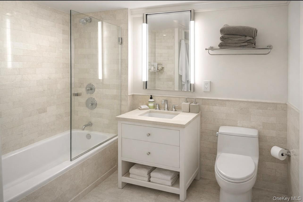 200 East 66th Street, Unit B1503 Manhattan, NY 10065 - Photo 16 of 24 a bathroom with a sink toilet and shower