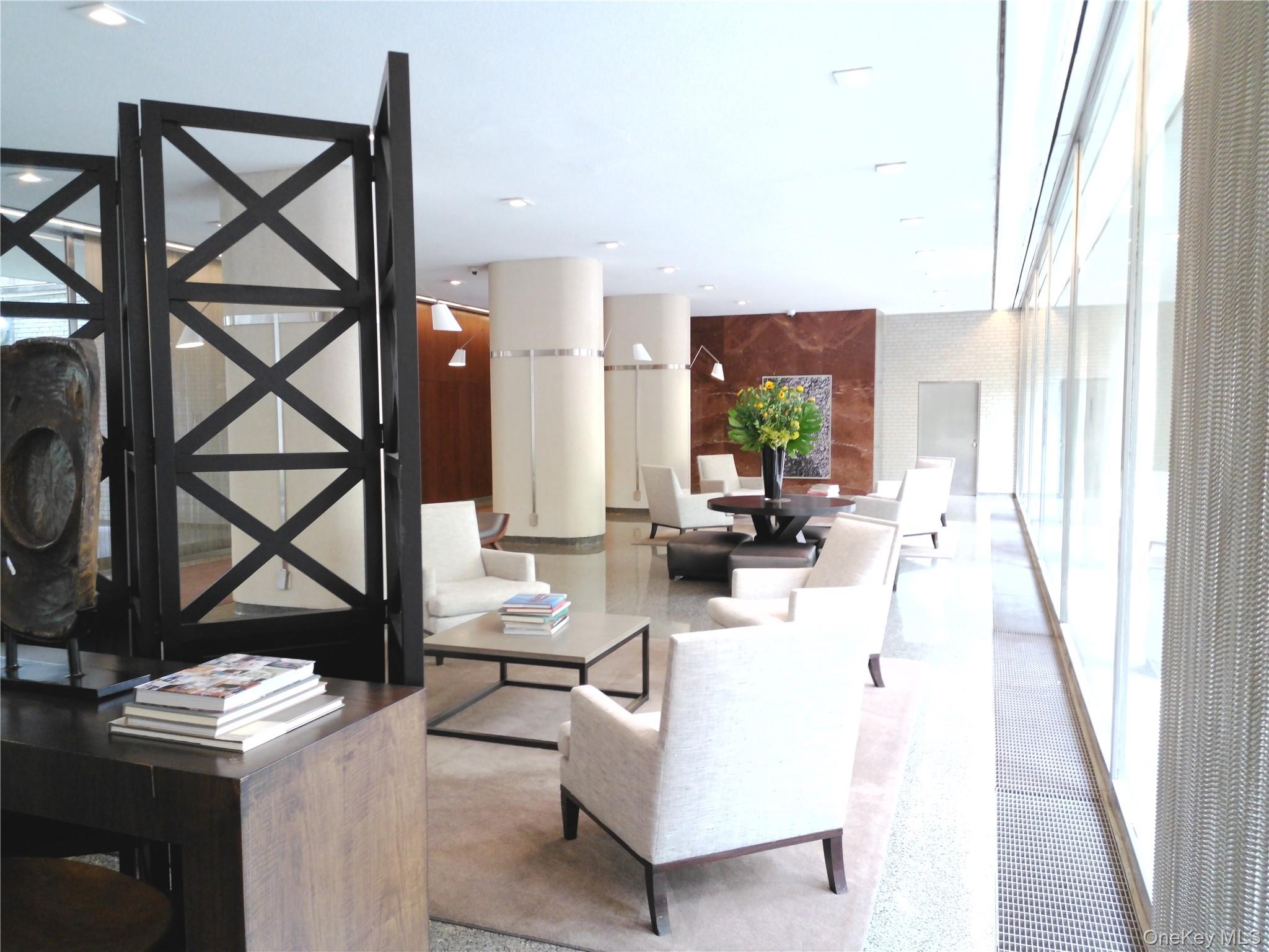 200 East 66th Street, Unit B1503 Manhattan, NY 10065 - Photo 17 of 24 a living room with furniture and a window