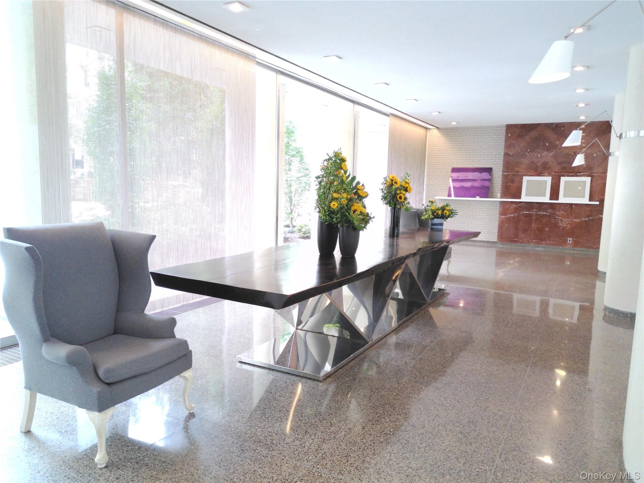 200 East 66th Street, Unit B1503 Manhattan, NY 10065 - Photo 19 of 24 a living room with furniture and a large window