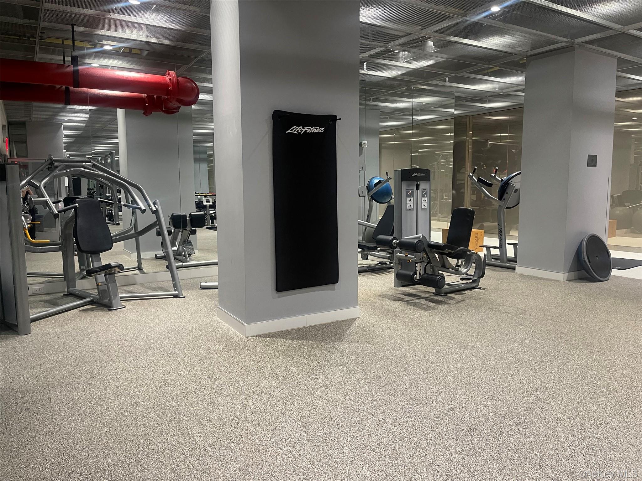 200 East 66th Street, Unit B1503 Manhattan, NY 10065 - Photo 20 of 24 a view of a room with gym equipment