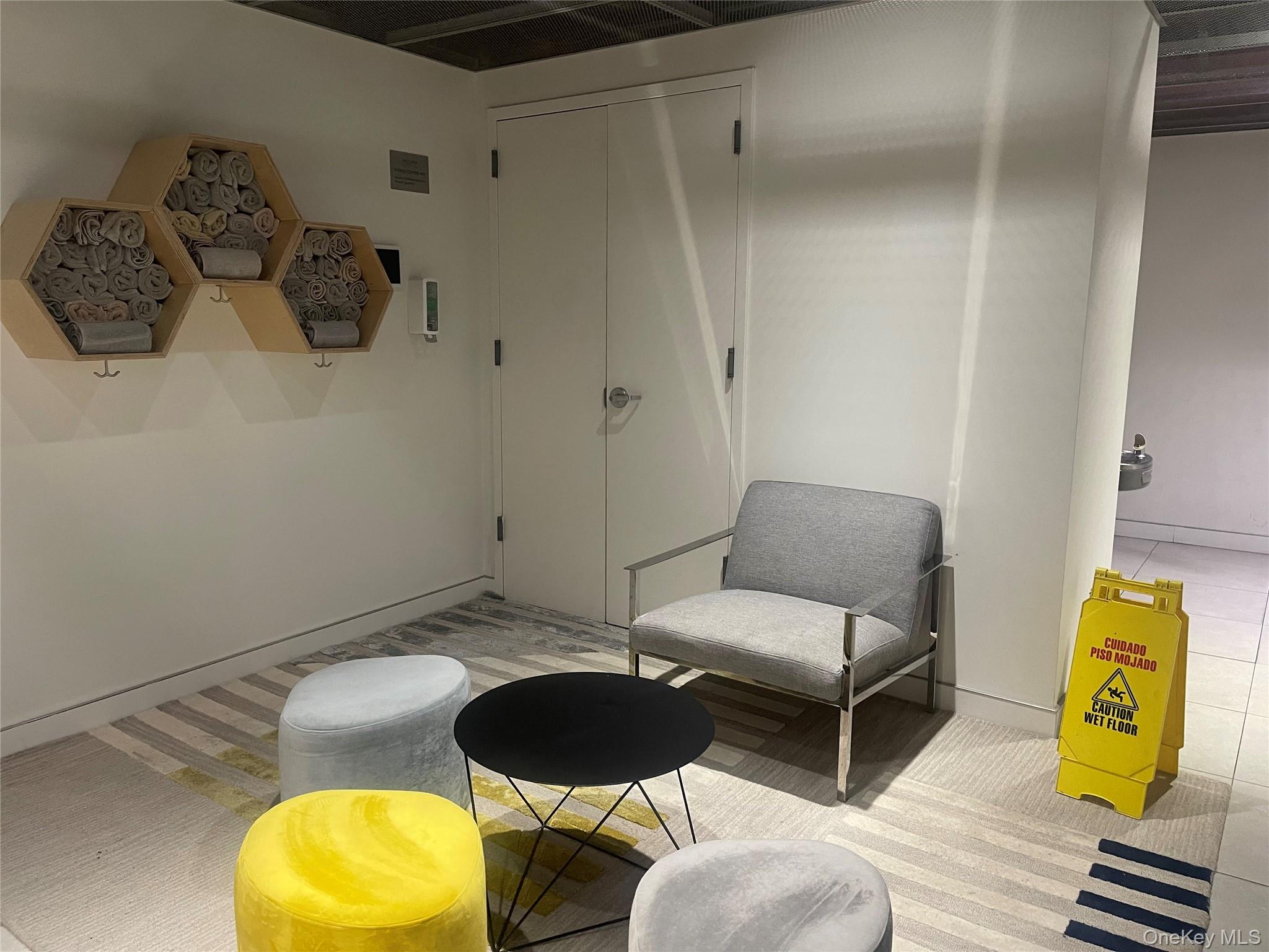 200 East 66th Street, Unit B1503 Manhattan, NY 10065 - Photo 21 of 24 a living room with furniture and a mirror