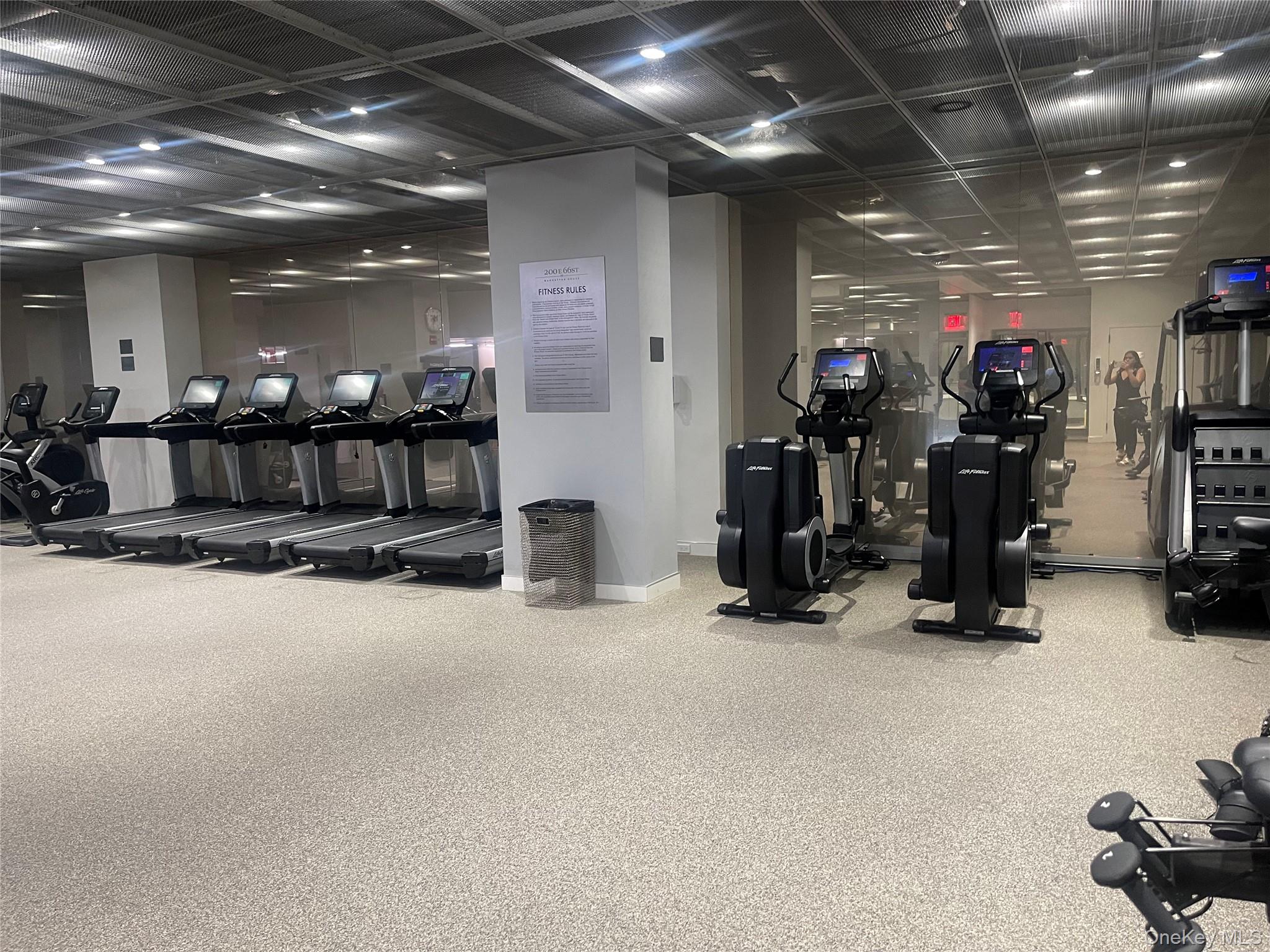 200 East 66th Street, Unit B1503 Manhattan, NY 10065 - Photo 23 of 24 a view of a room with gym equipment