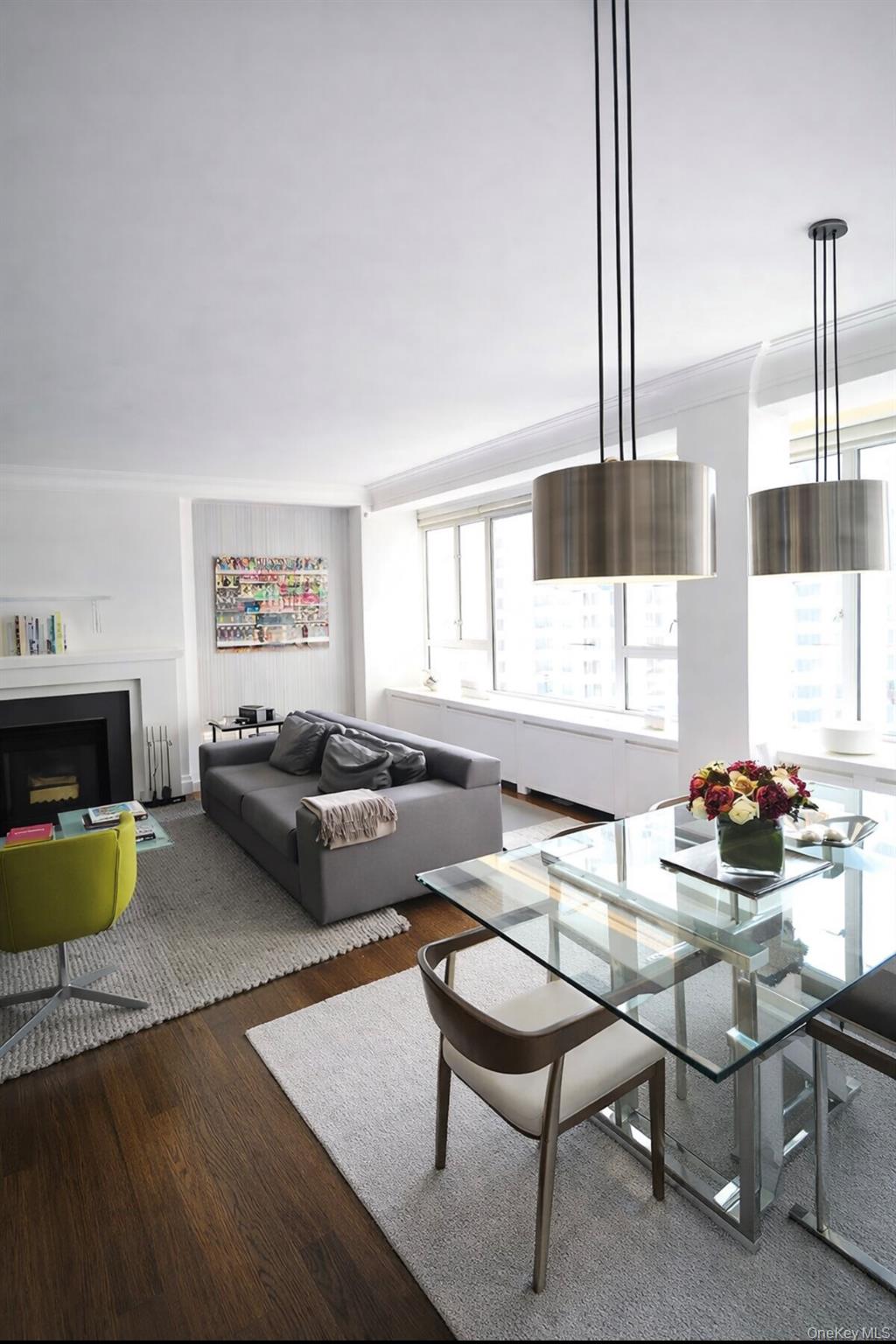 200 East 66th Street, Unit B1503 Manhattan, NY 10065 - Photo 4 of 24 a living room with furniture and a wooden floor