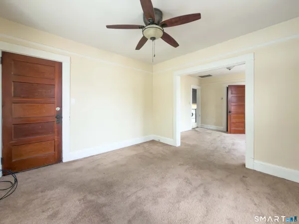 a view of empty room with ceiling fan