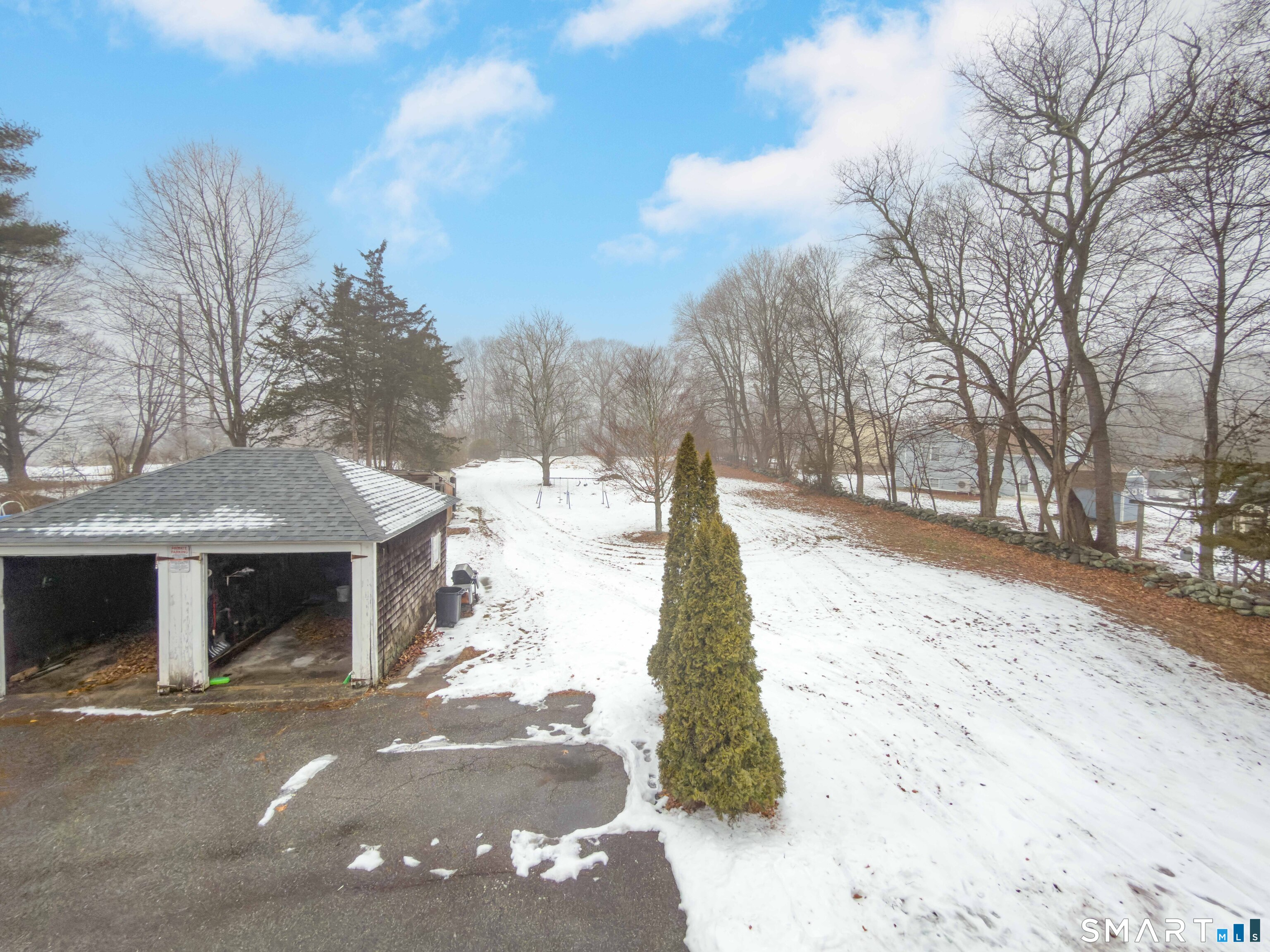 72 Roosevelt Avenue Norwich, CT 06360 - Photo 2 of 21 a view of a yard with snow on the road