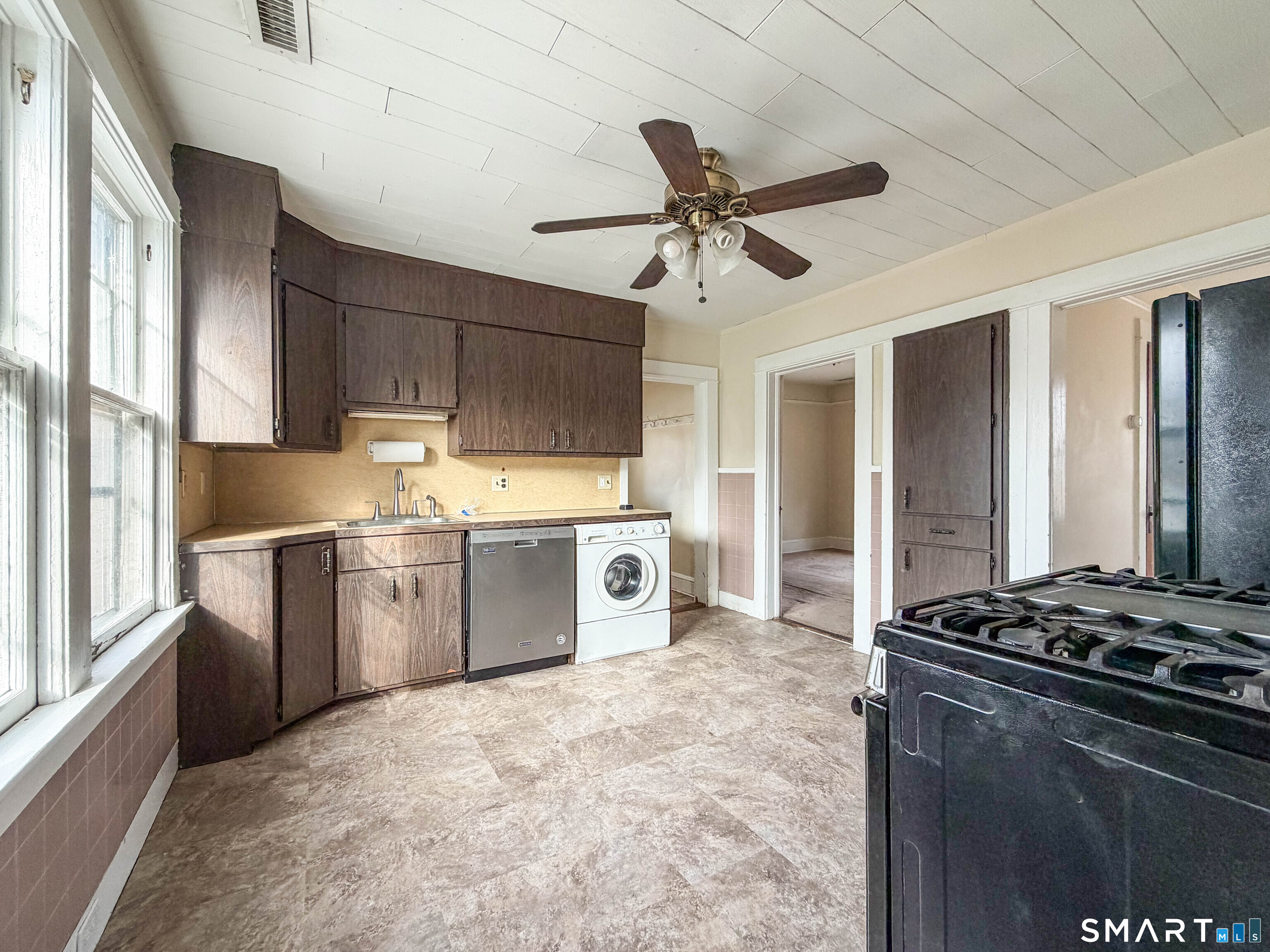 72 Roosevelt Avenue Norwich, CT 06360 - Photo 6 of 21 a kitchen with a stove a sink and a refrigerator