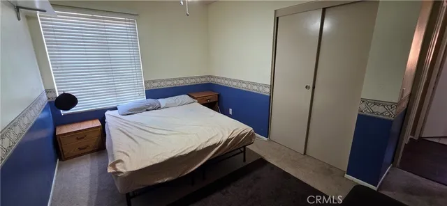 a bedroom with a bed and a mirror