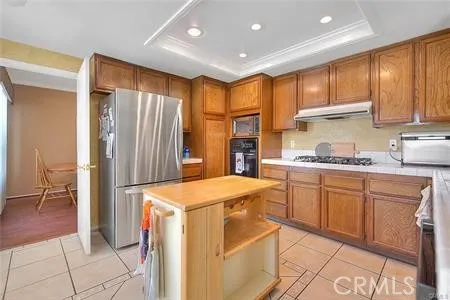 a kitchen with granite countertop cabinets and refrigerator