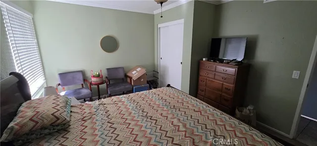 a bedroom with a bed and flat screen tv