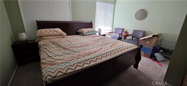 a bedroom with bed and window