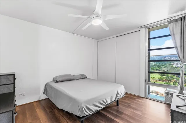 a bedroom with a bed and a large window