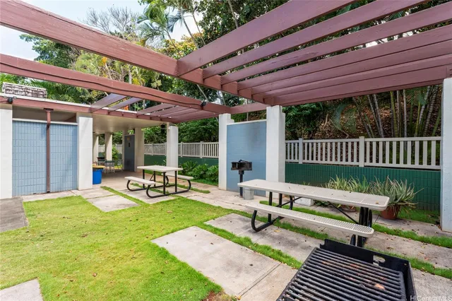 a view of a patio with a table chairs and a backyard