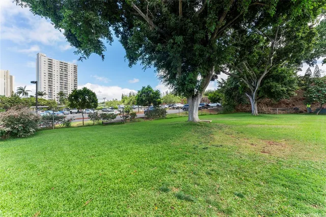 a view of a garden with a building in the background