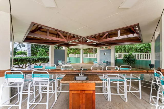 a view of a patio with a dining table and chairs with wooden floor