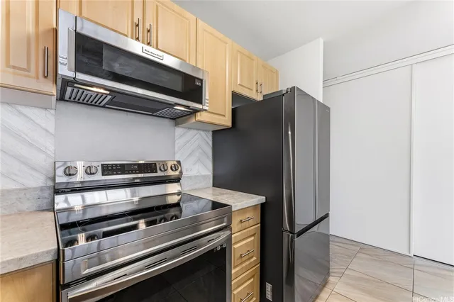 a kitchen with stainless steel appliances and wood cabinets