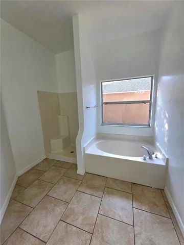 a view of room with window and a bath tub