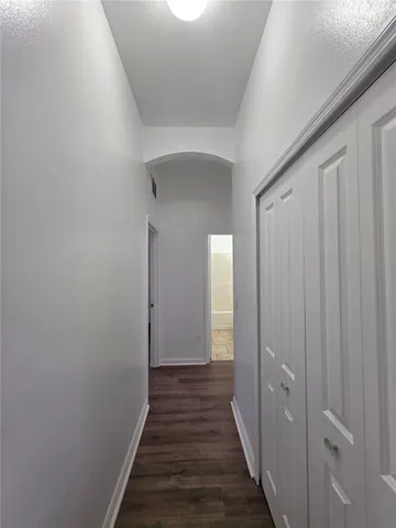 a view of a hallway with wooden floor