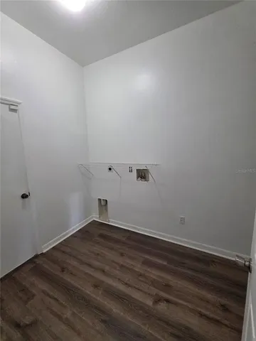 a view of a room with wooden floor