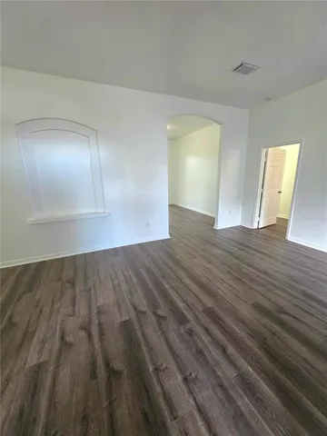 a view of an empty room and wooden floor