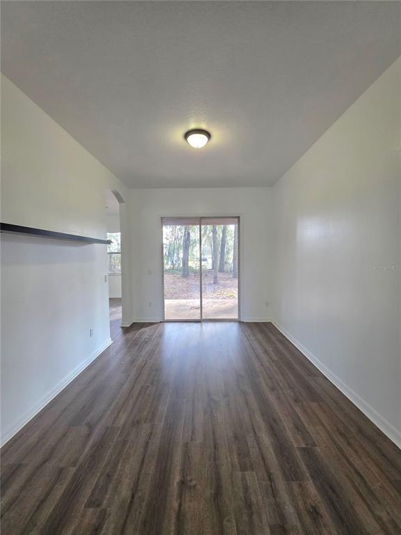 2818 Northeast 24th Place Ocala, FL 34470 - Photo 5 of 20 an empty room with wooden floor and windows