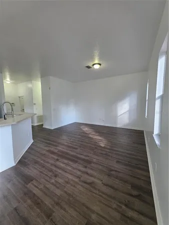 a view of a room with wooden floor and staircase