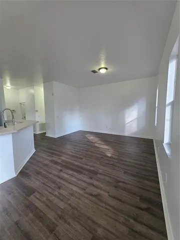 a view of a room with wooden floor and staircase