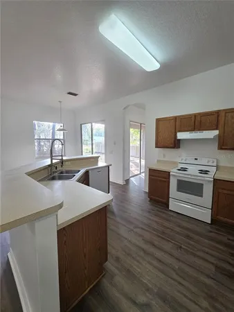 a kitchen with stainless steel appliances a stove top oven