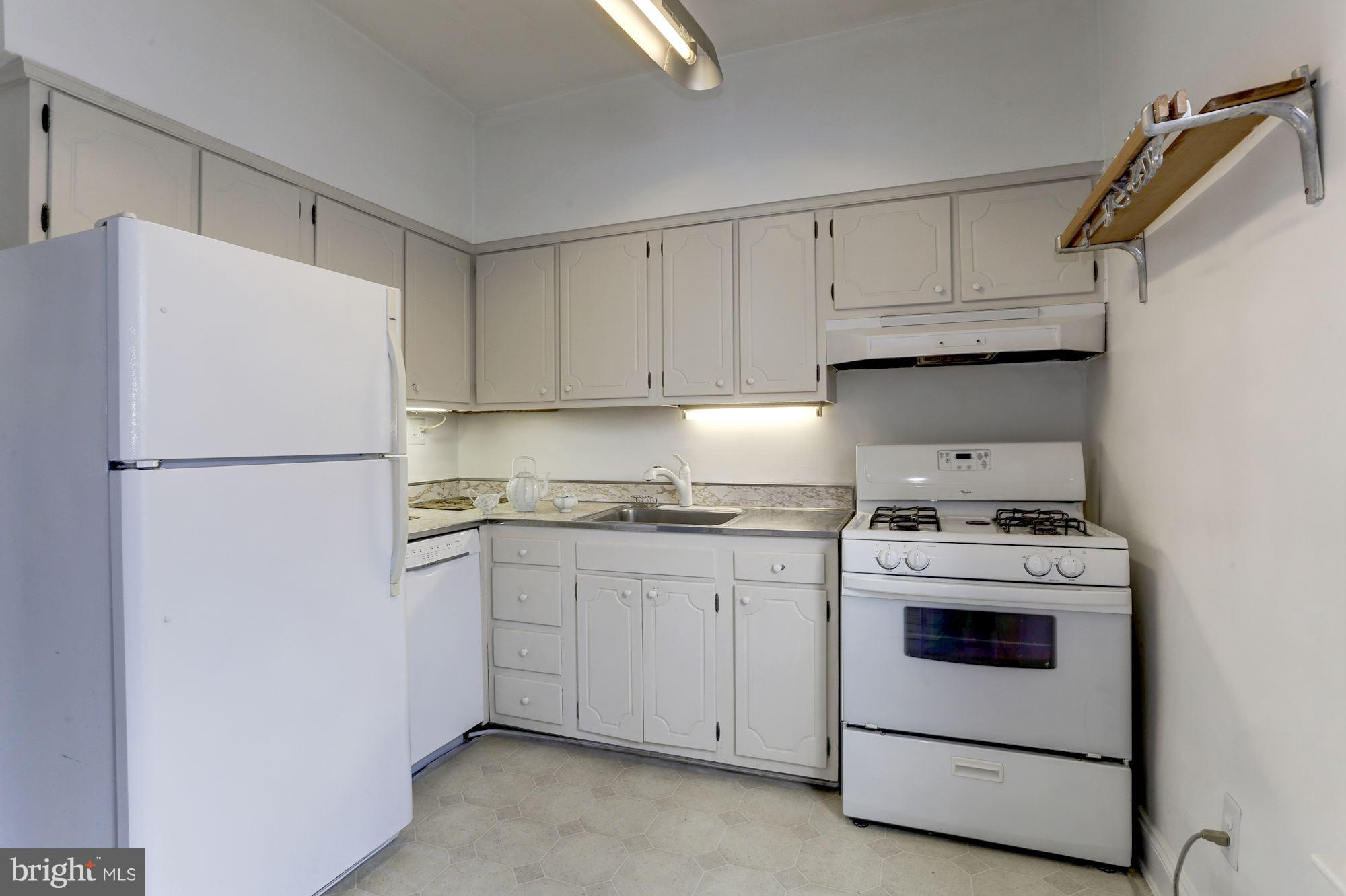 3022 R Street Northwest, Unit 3 Washington, DC 20007 - Photo 11 of 24 Kitchen with gas stove, dishwasher, refrigerator.
