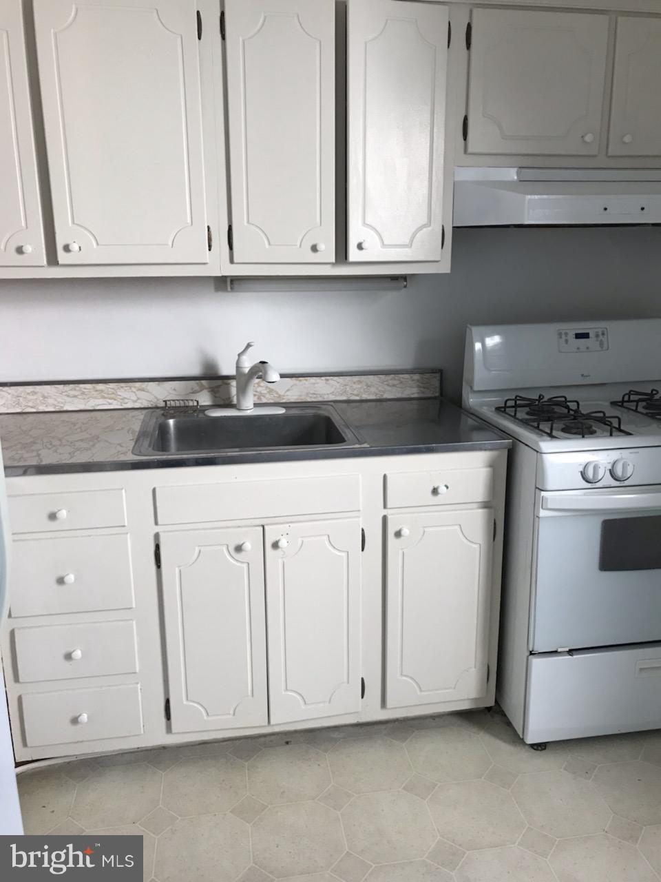 3022 R Street Northwest, Unit 3 Washington, DC 20007 - Photo 12 of 24 Kitchen - with a gas stove.