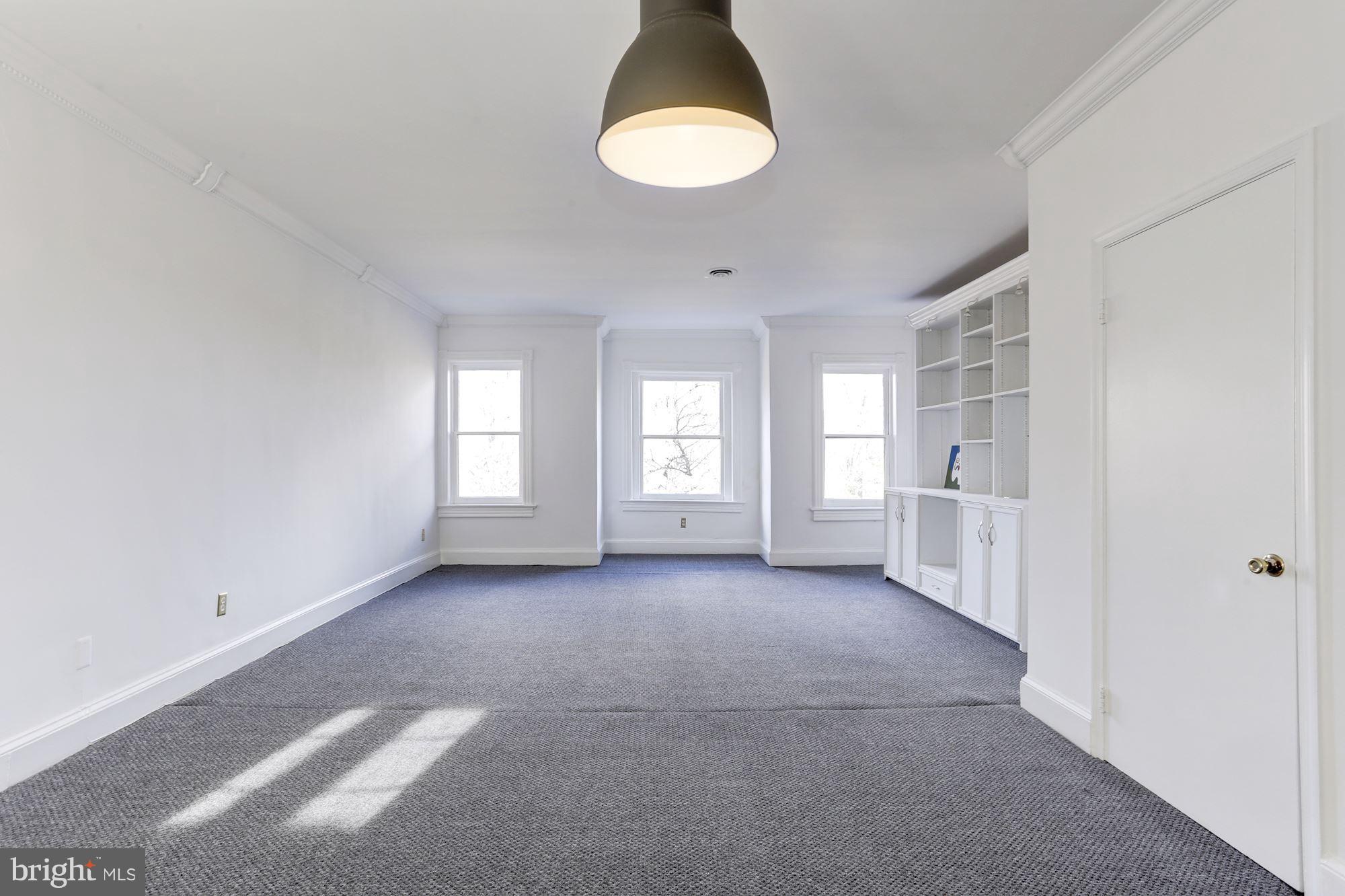 3022 R Street Northwest, Unit 3 Washington, DC 20007 - Photo 6 of 24 Living Room - 2nd view of bookcase and windows.