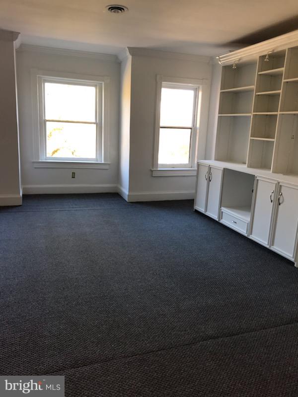3022 R Street Northwest, Unit 3 Washington, DC 20007 - Photo 8 of 24 Living Room with 3 large windows and bookcase.