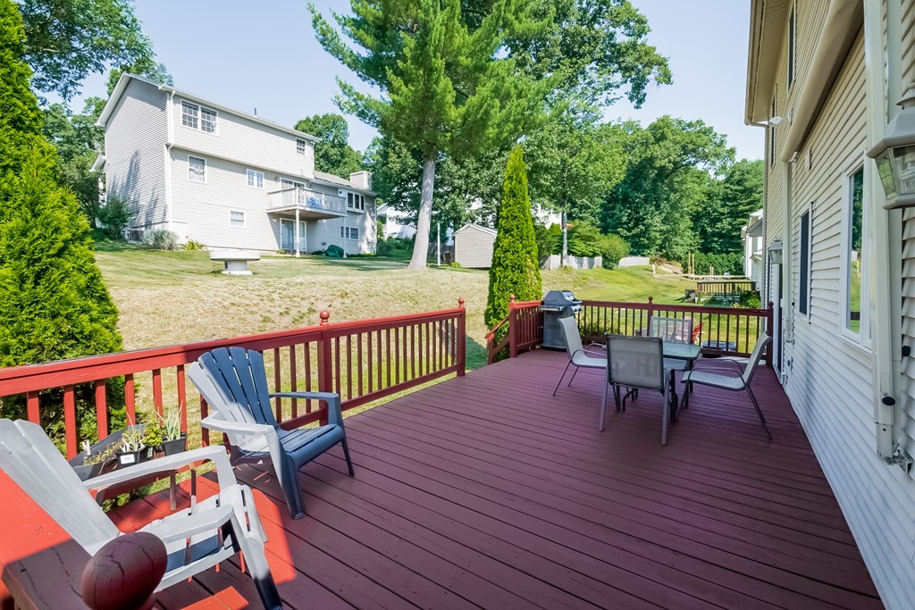 46 Gates Avenue Springfield, MA 01118 - Photo 24 of 26 a view of a deck with table and chairs with wooden floor and fence