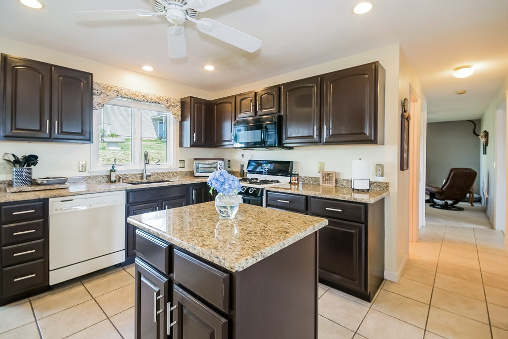 46 Gates Avenue Springfield, MA 01118 - Photo 4 of 26 a kitchen with a sink a microwave and cabinets