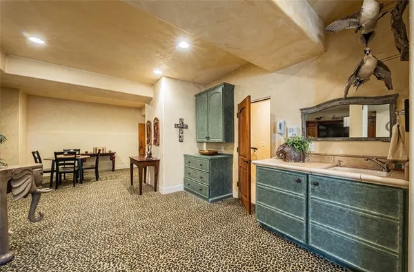 a bathroom with a granite countertop sink a toilet and a mirror