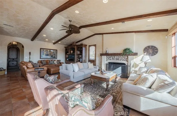 a large kitchen with kitchen island a stove a sink a counter space dining table and chairs