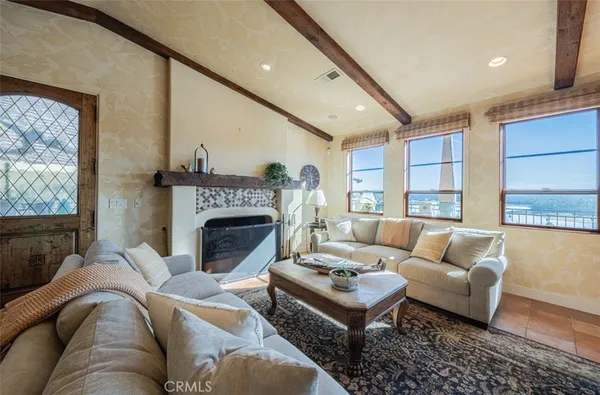 a view of a dining room and livingroom with furniture wooden floor a chandelier