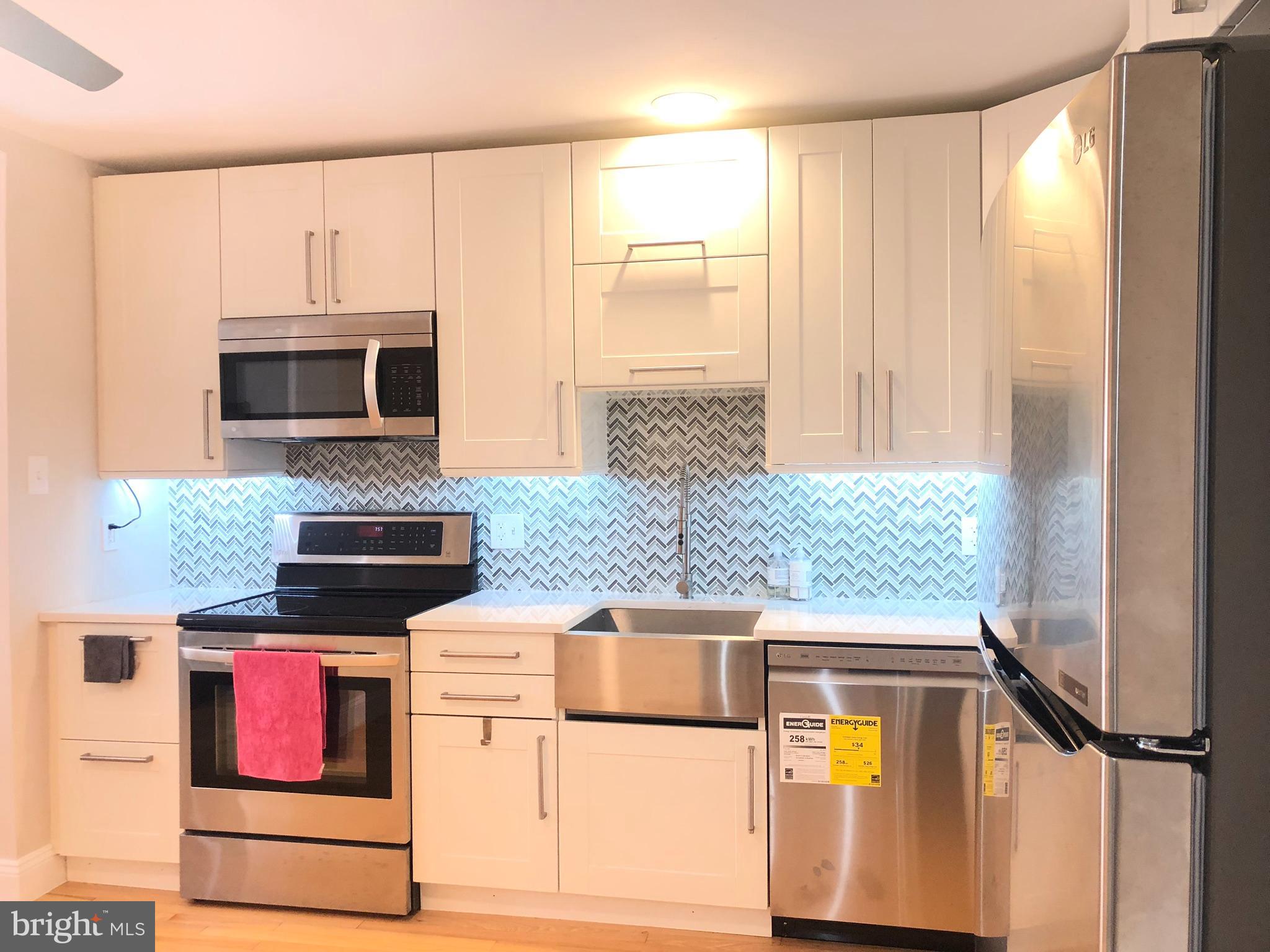 5 Algonquin Court Chesterbrook, PA 19087 - Photo 1 of 18 a kitchen with a stove a microwave and refrigerator