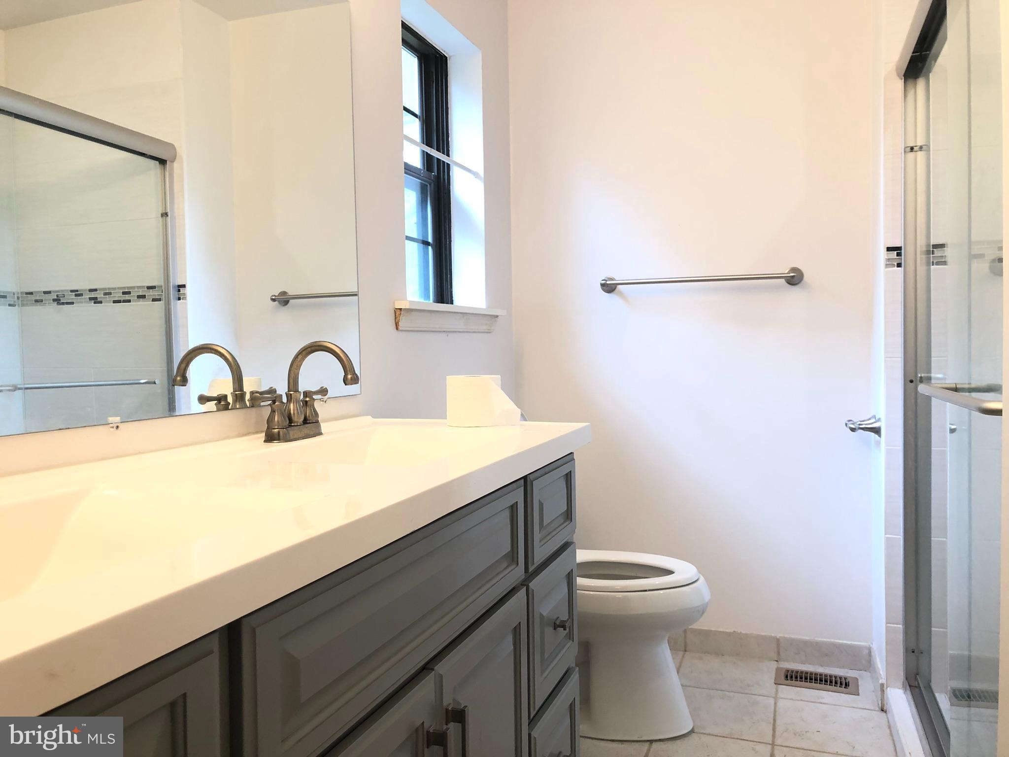 5 Algonquin Court Chesterbrook, PA 19087 - Photo 13 of 18 a bathroom with a sink a toilet and shower