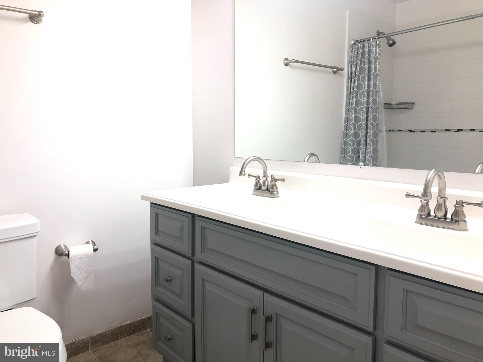 5 Algonquin Court Chesterbrook, PA 19087 - Photo 15 of 18 a bathroom with a sink and a mirror