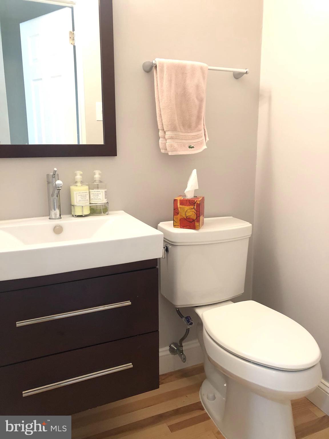 5 Algonquin Court Chesterbrook, PA 19087 - Photo 5 of 18 a bathroom with a toilet sink and mirror