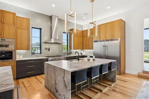 a kitchen with a sink a stove a refrigerator and cabinets