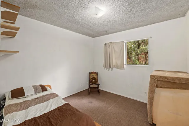 a living room with a bed and furniture